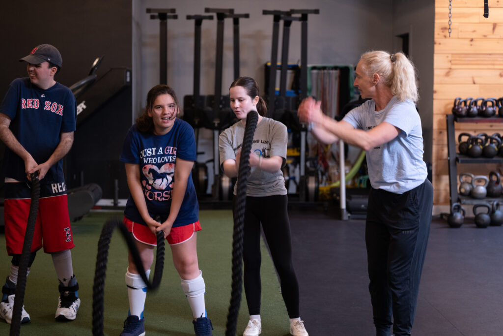 Adaptive fitness coach providing individualized support during strength and conditioning class